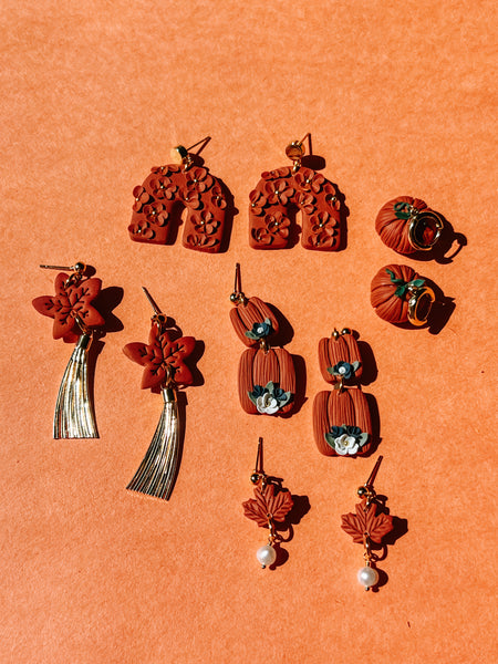 Collection of earrings on an orange background